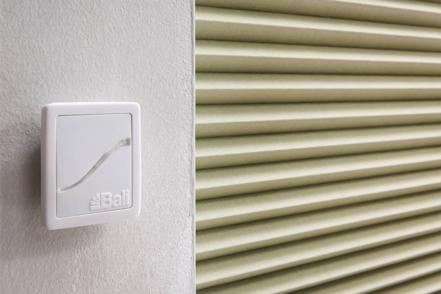 Bali AutoView remote control mounted near a cellular shade