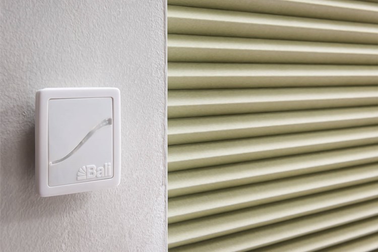 Bali AutoView remote control mounted near a cellular shade